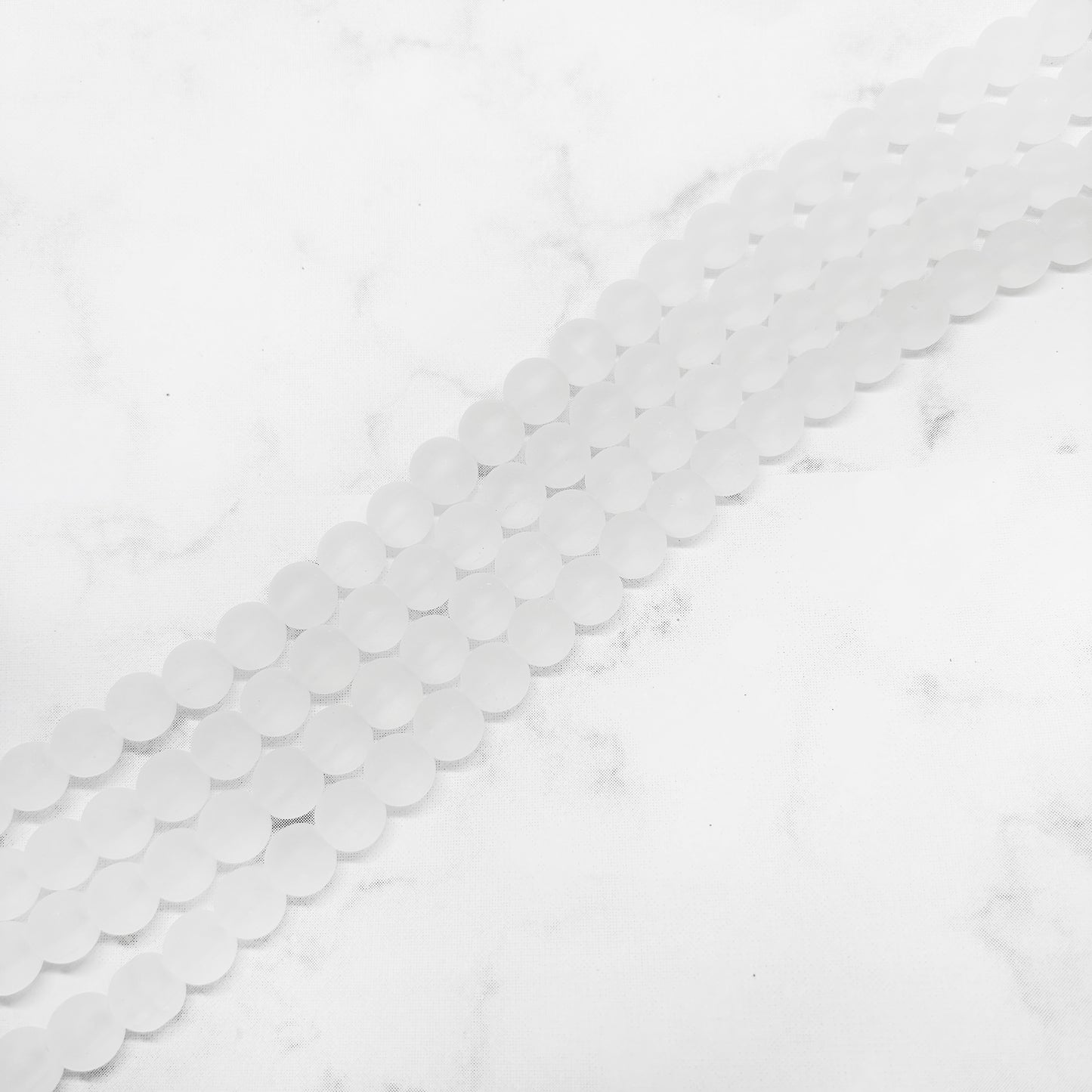 Perla de vidrio matte transparente - 8mm - Tira 50und aprox. - Blanco