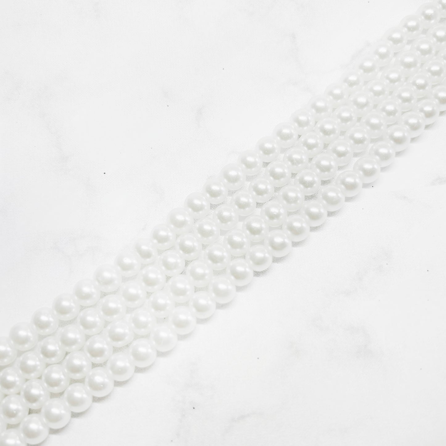 Perla de vidrio brillante - 6mm - Tira 65und aprox. - Blanco